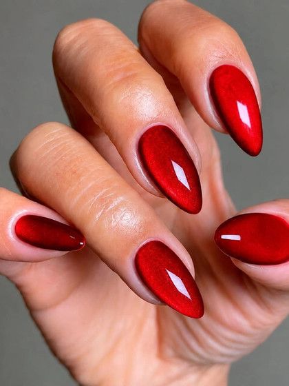 Bright red cat eye almond nails, glossy red with a bright magnetic band