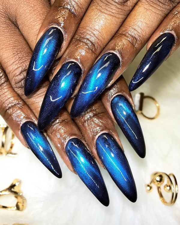 Electric blue cat eye long stiletto nails on dark skin, vivid blue magnetic stilettos