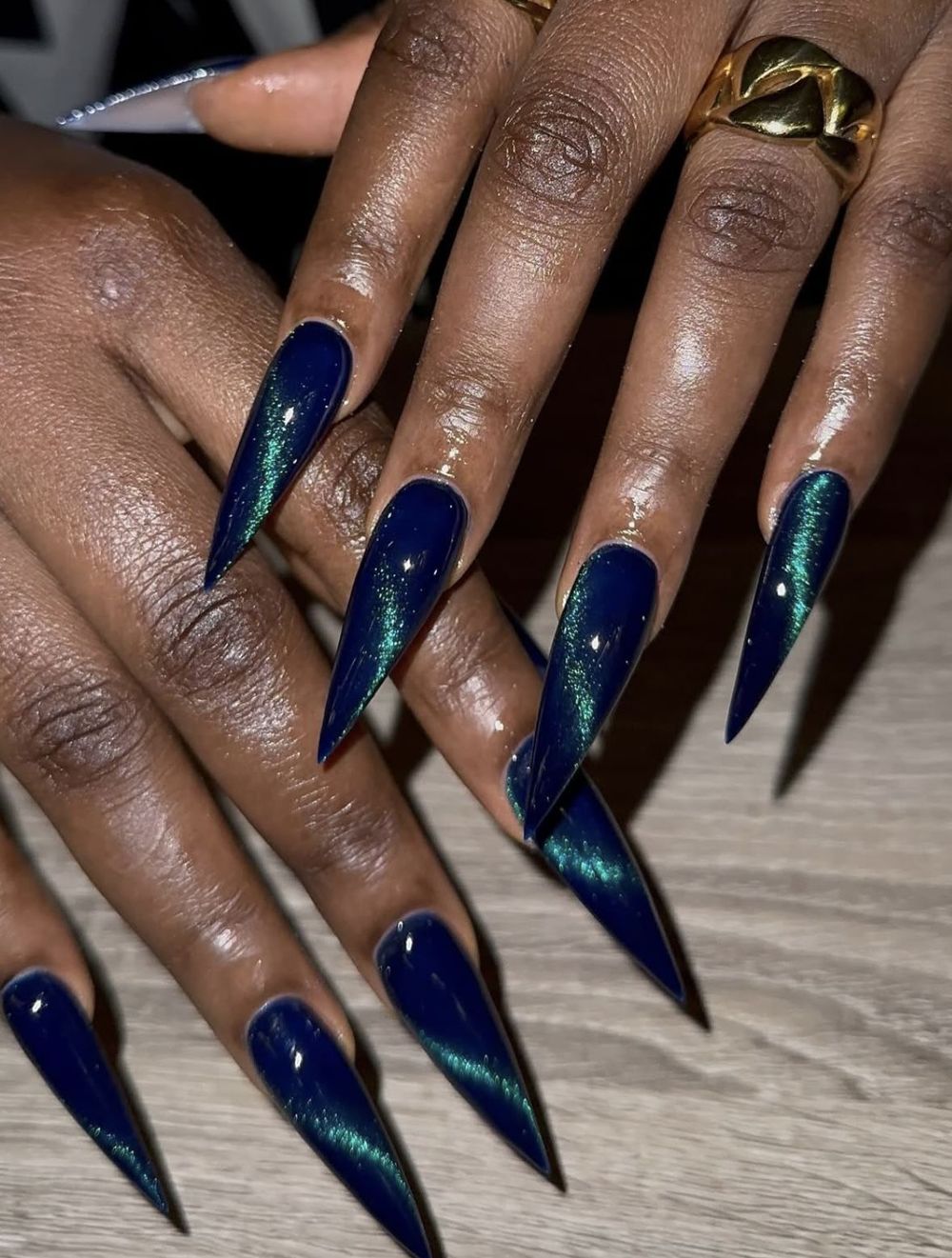 Navy cat eye long stiletto nails on dark skin, deep blue magnetic stilettos