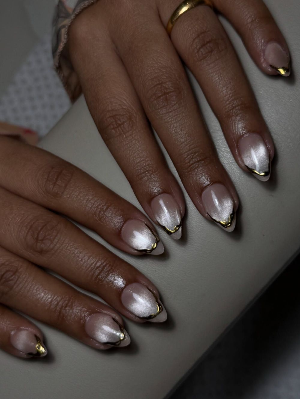 Silver French cat eye nails on dark skin, silver magnetic tips over a bare base