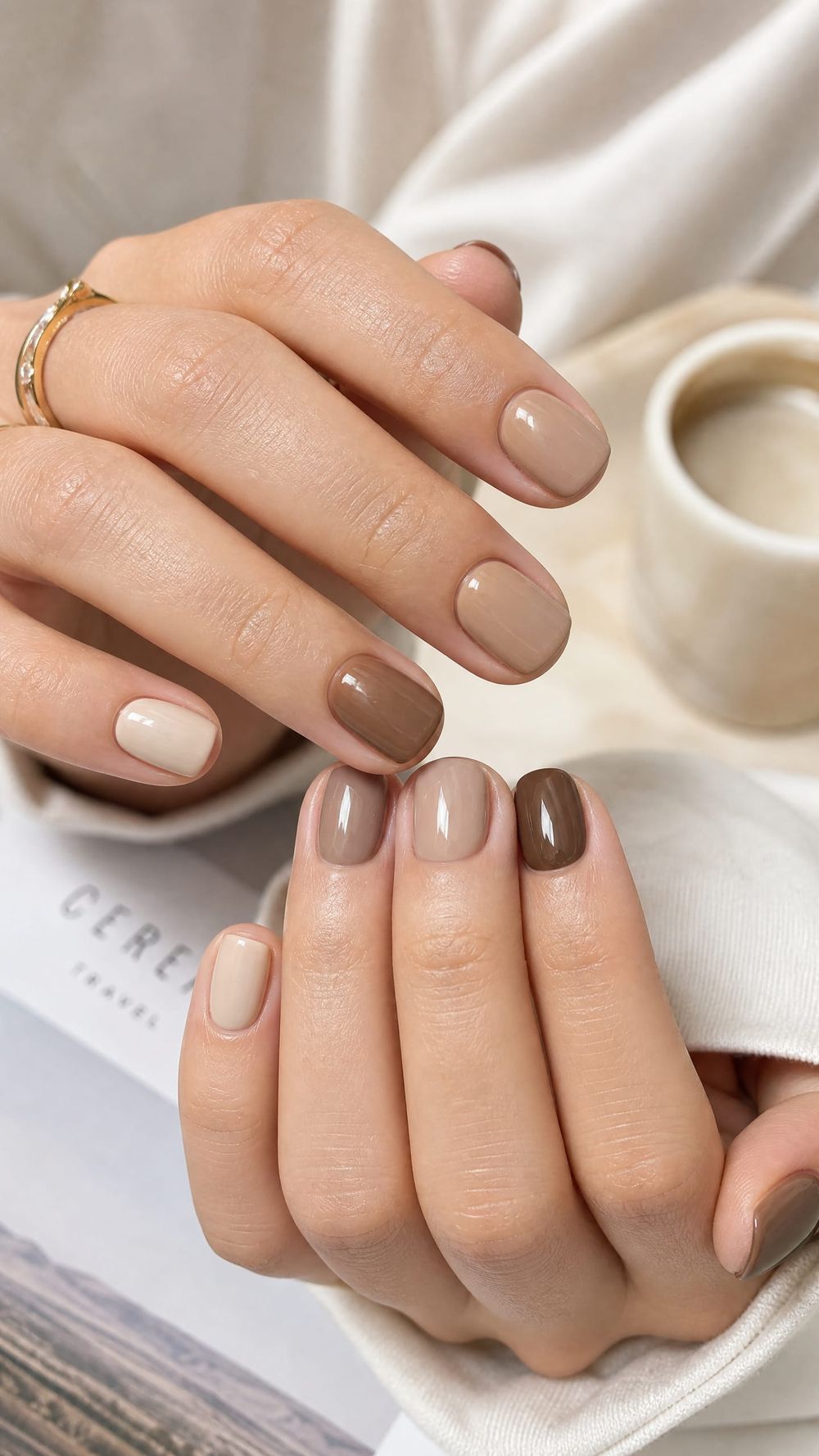 Beige and brown mix nails with a coffee cup, neutral coffee shades styled with a cup