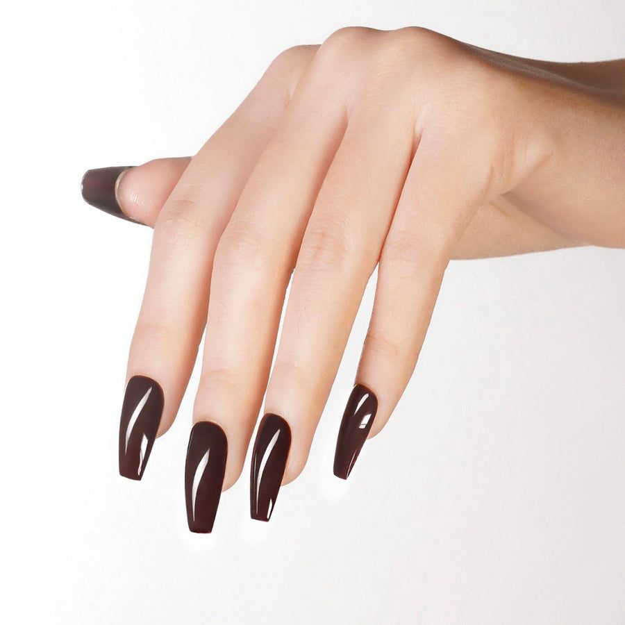 Dark chocolate coffin nails on white, deep brown coffins against a white backdrop