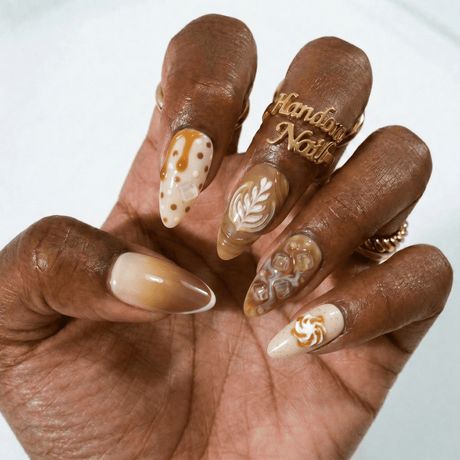 Latte art almond nails on dark skin, caramel base with cream rosetta art on deep skin