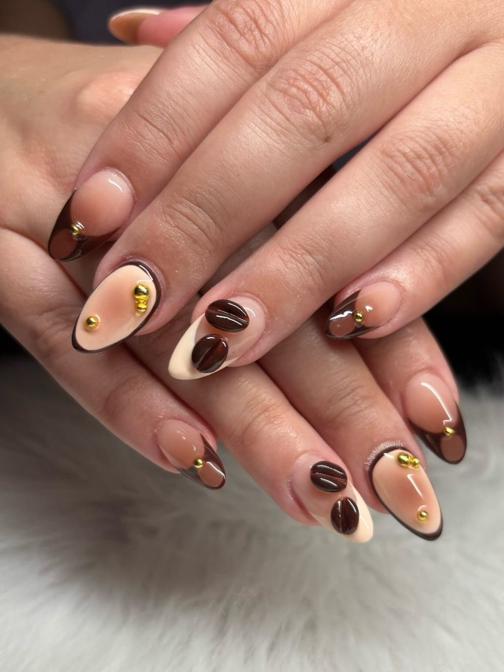 Nude almond nails with coffee bean art, bare nails with tiny painted beans