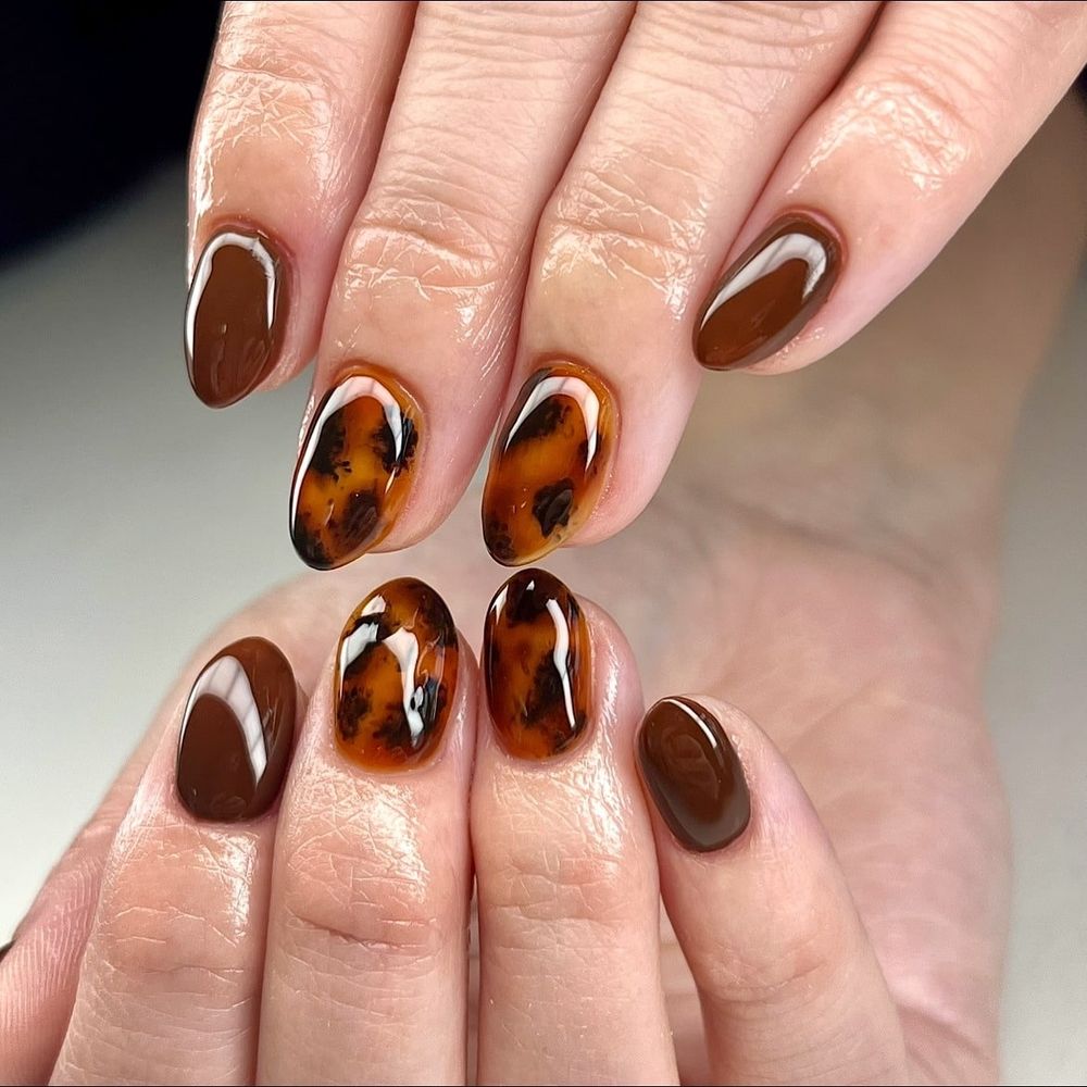 Tortoiseshell almond nails with chocolate, amber marble deepened with chocolate brown