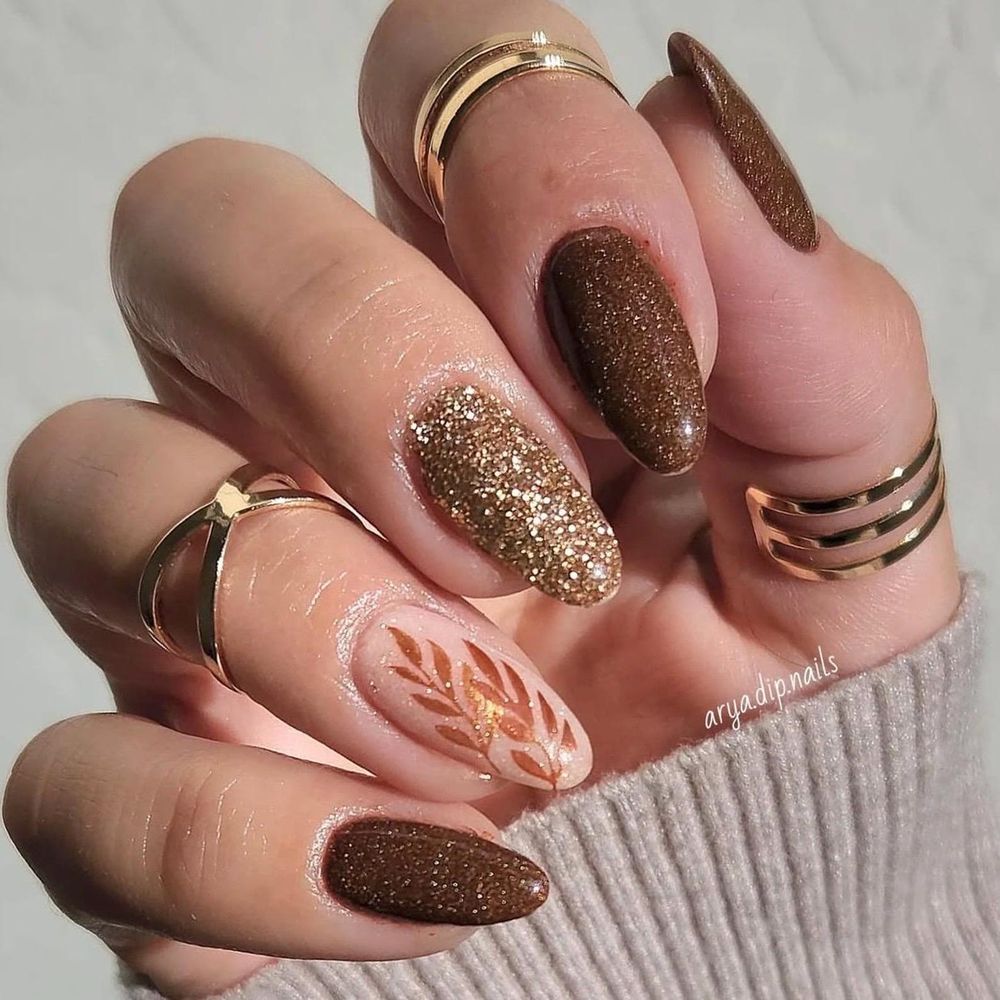 Chocolate and gold almond nails with glitter and leaf art, sparkling brown set