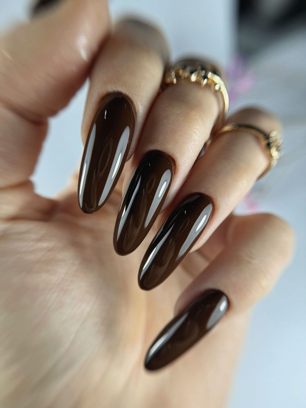 Glossy espresso brown almond nails, long dark chocolate gel set with gold rings