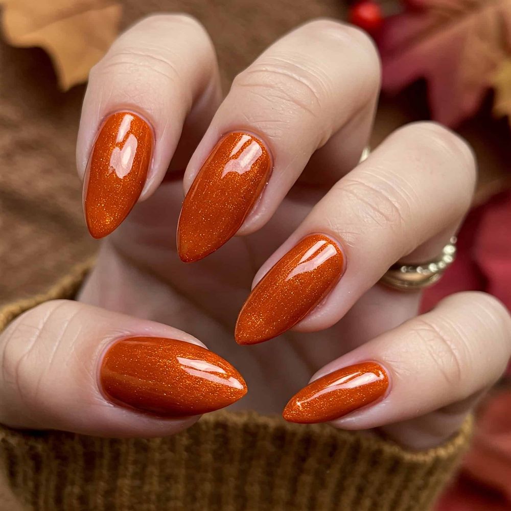 Orange glitter almond nails in a knit sleeve, sparkling pumpkin orange gel set
