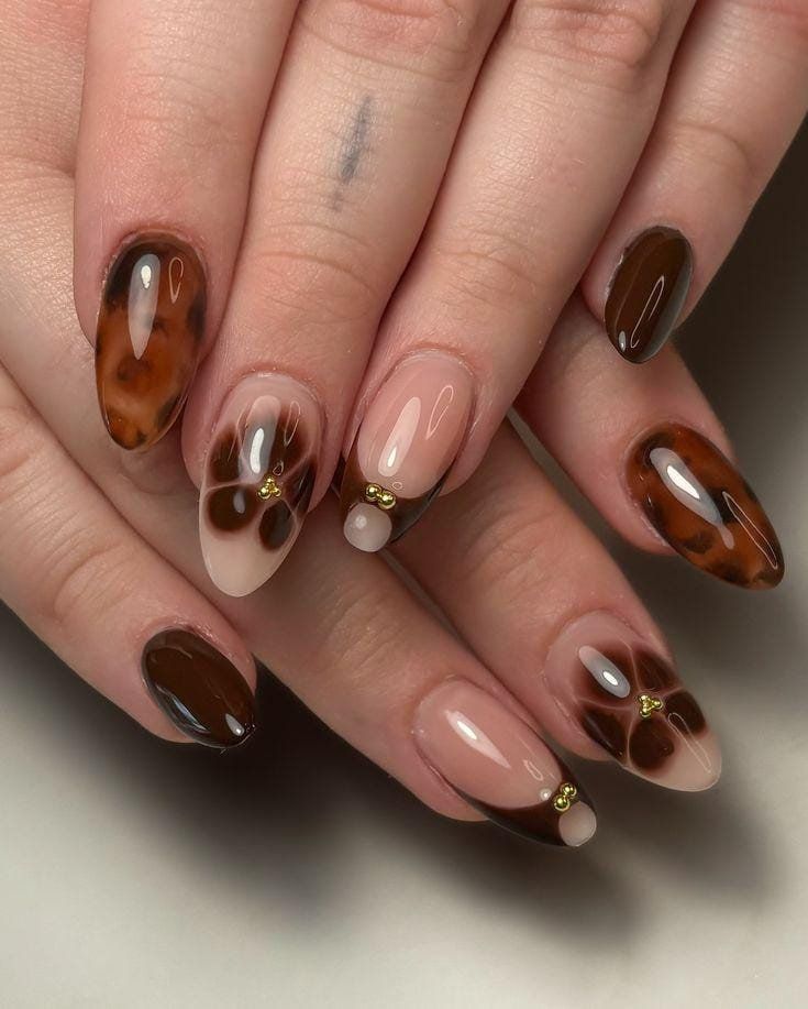 Tortoise and nude almond nails with brown floral bow art accents
