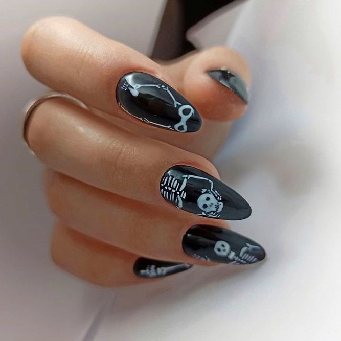 Black almond nails with white skeleton and skull art, glossy Halloween design
