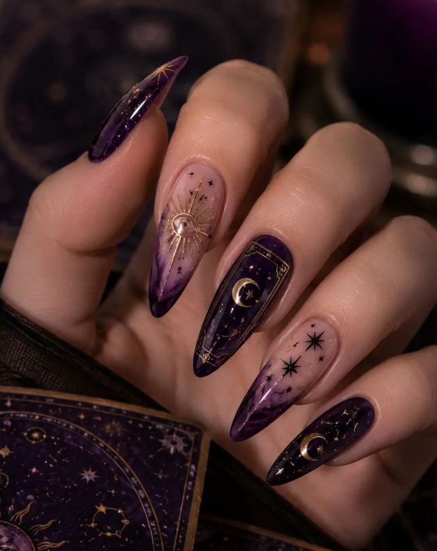 Deep purple stiletto nails on dark skin with gold celestial and spider art