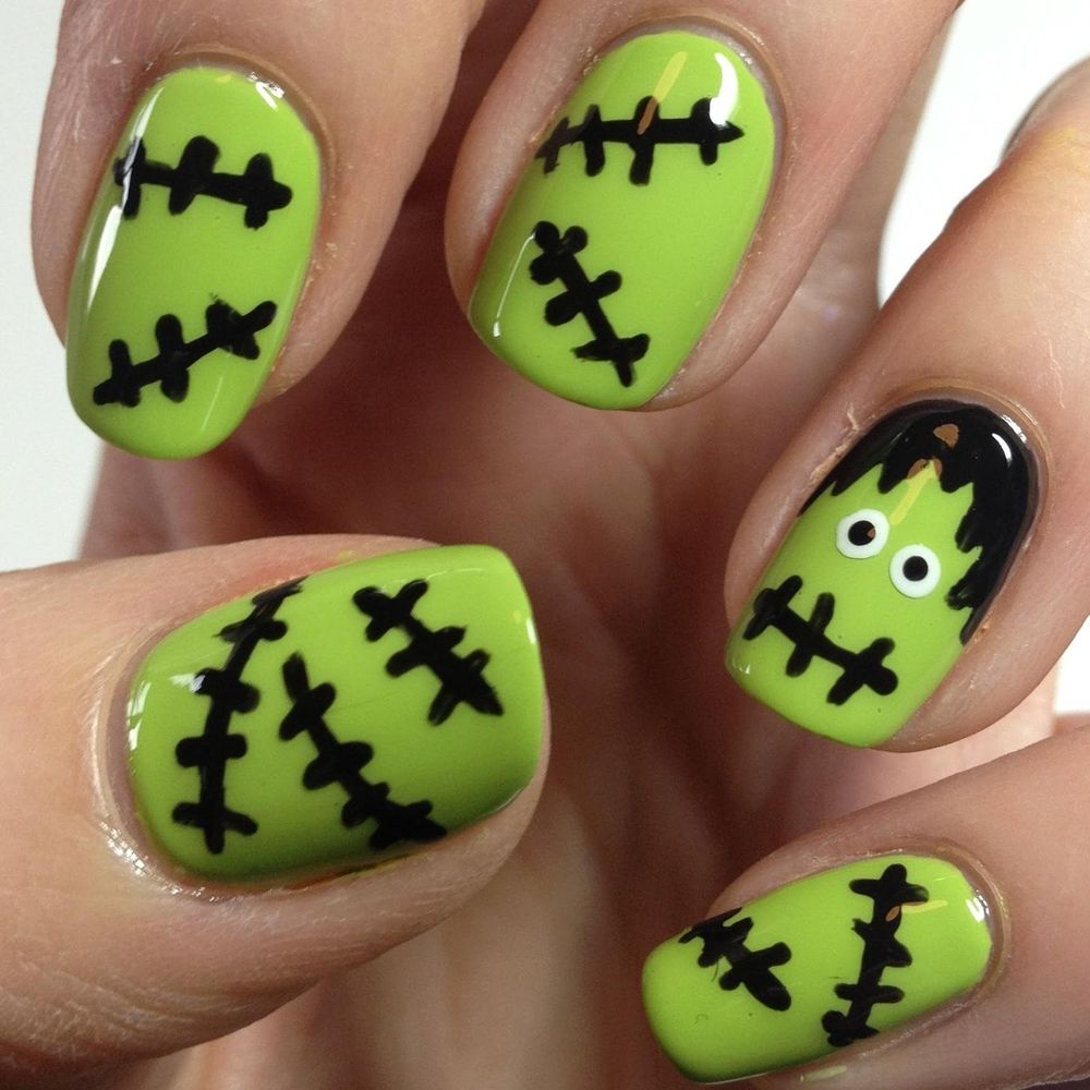 Short green nails with black Frankenstein stitch art and a Frankenstein face accent nail