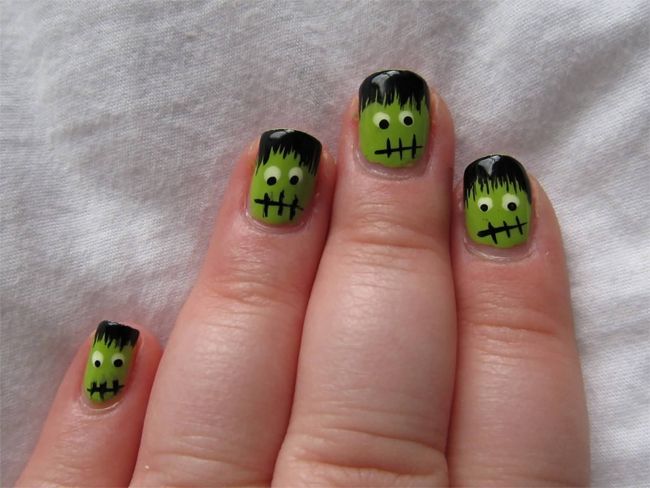 Short green nails with tiny Frankenstein face art on each nail, playful Halloween design