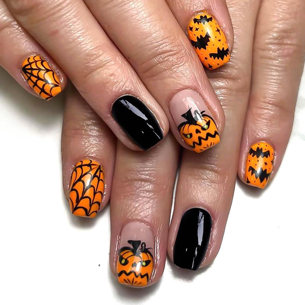 Short orange and black nails with pumpkin faces, spiderwebs and bat details