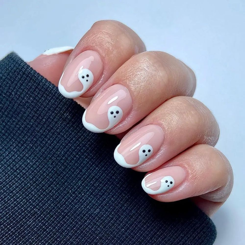 Short pink nails with white ghost French tips, soft Halloween nail art
