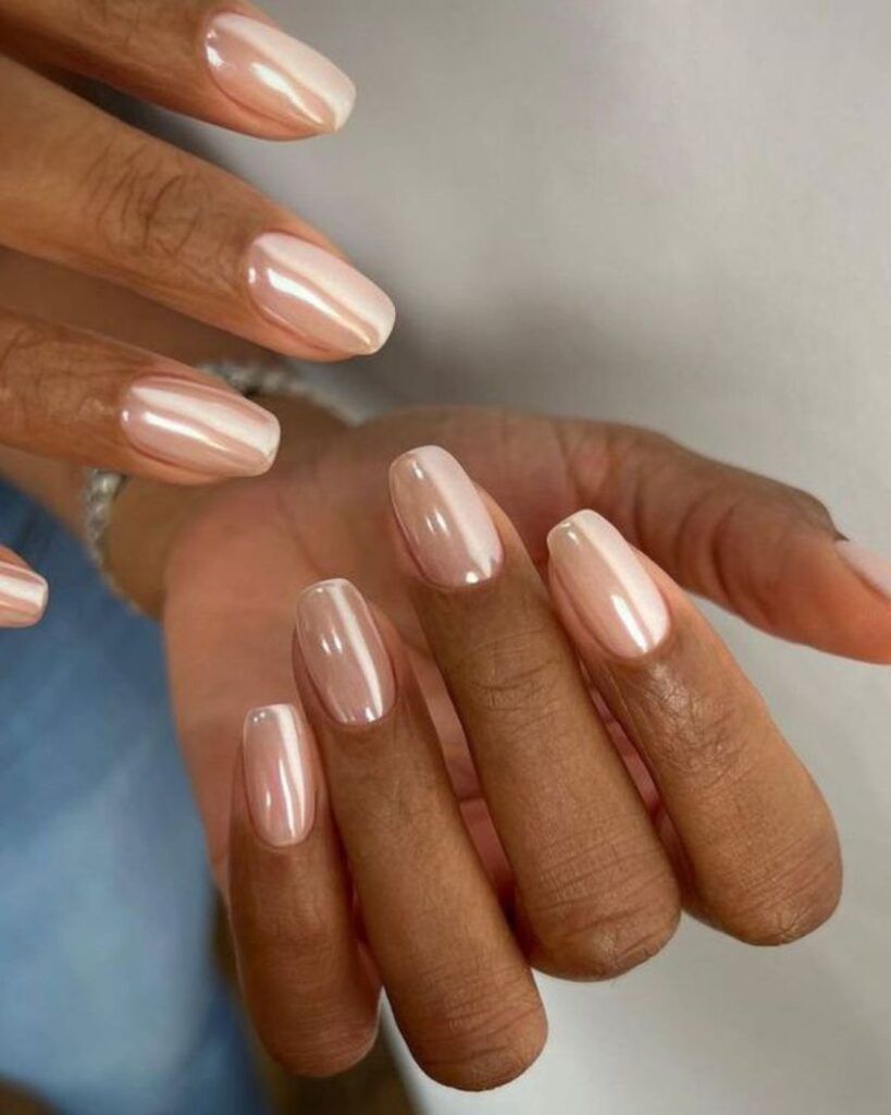 Champagne pearl jelly chrome oval nails on brown skin, soft champagne glow