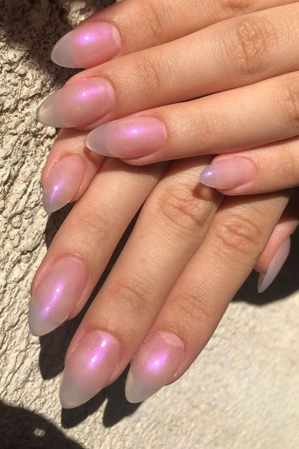 Pink aura jelly chrome almond nails in sunlight, pink glow in direct sun