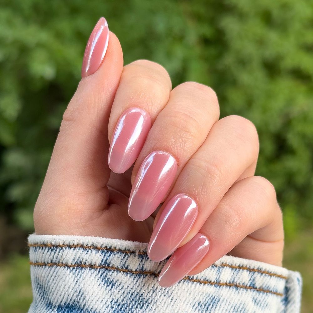Pink jelly chrome almond nails outdoors, soft pink glazed set in daylight