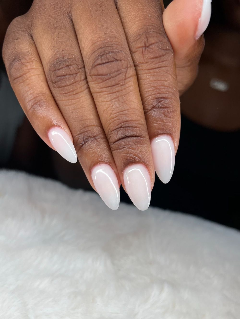 Milky pink ombre almond nails on dark skin, blush gradient glow on deep skin