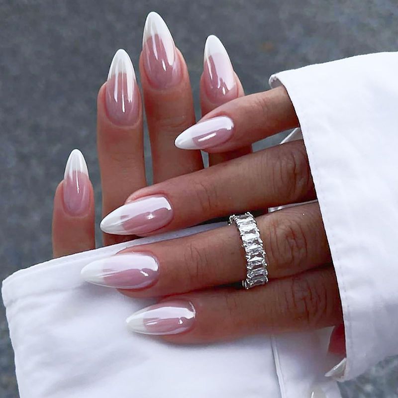 Milky pink ombre French tips on almond nails, pink fade with white tips