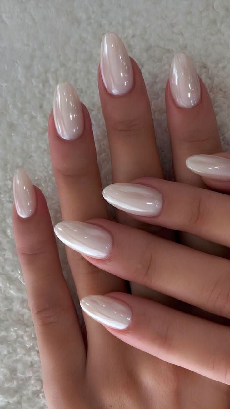 Milky white chrome almond nails on two hands, matching glazed white set