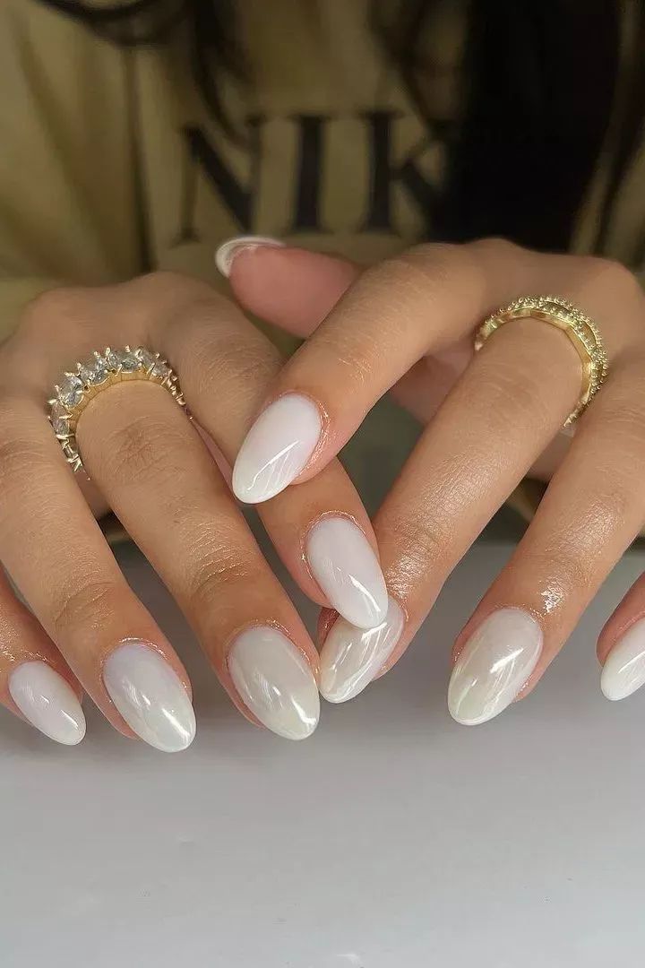 Milky white chrome oval nails with gold rings, glowing white ovals with gold