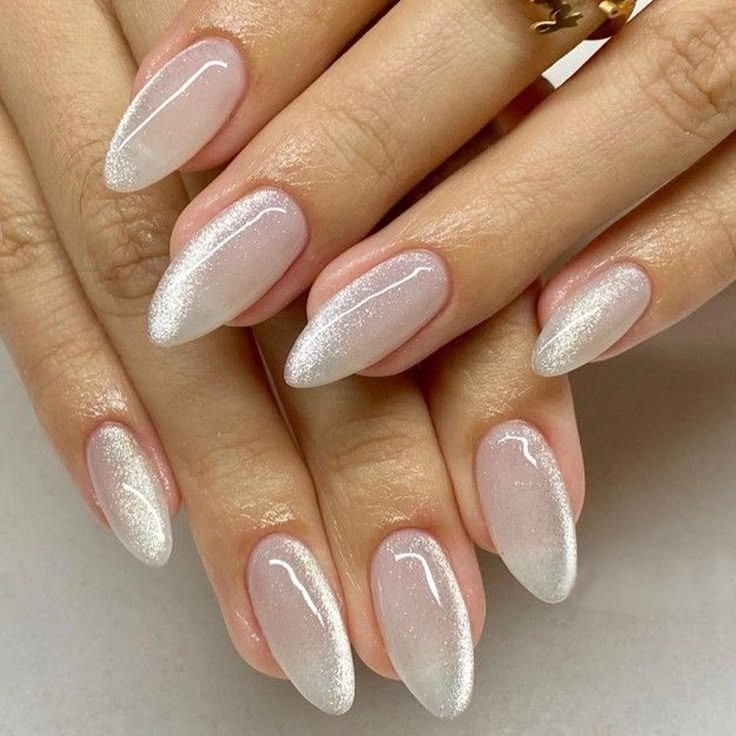 Silver glitter French ombre almond nails, glitter tips fading into milky white