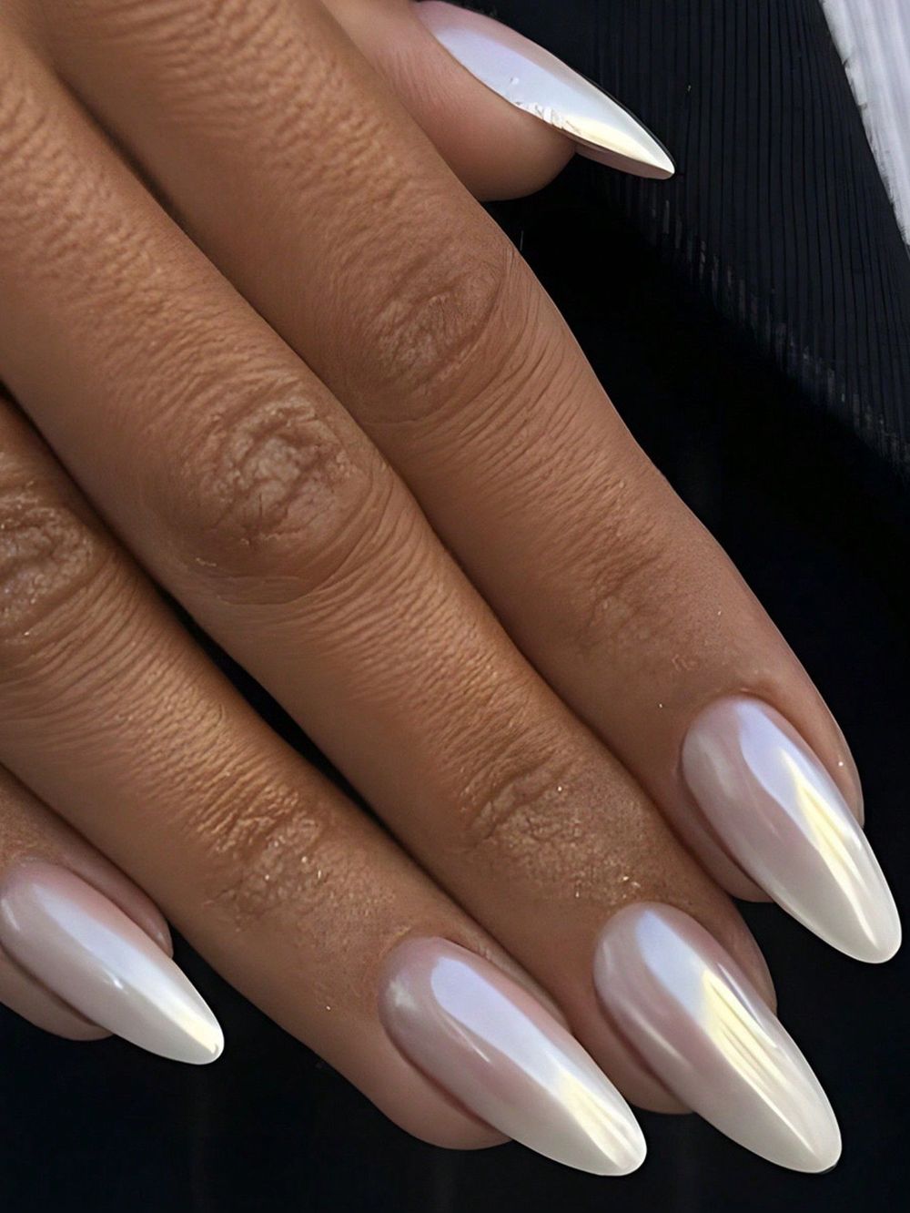 White chrome long almond nails on dark skin, glowing white at length