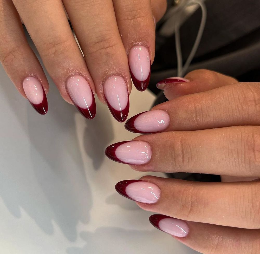 Burgundy French oval nails duo, wine tips shown on two hands