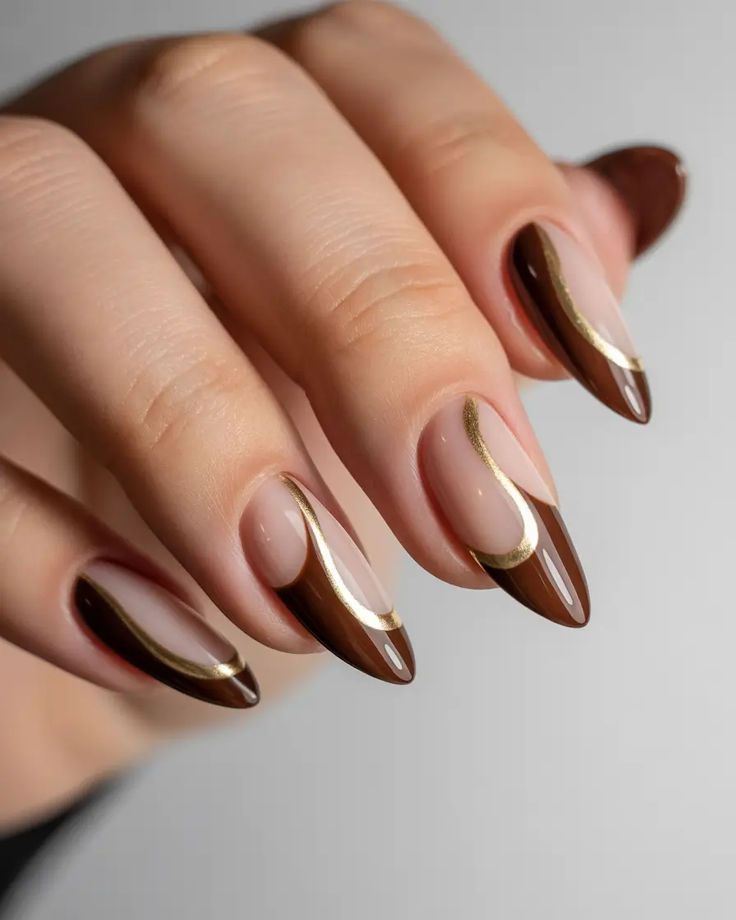 Chocolate French almond nails with gold swirls, brown tips with metallic gold lines