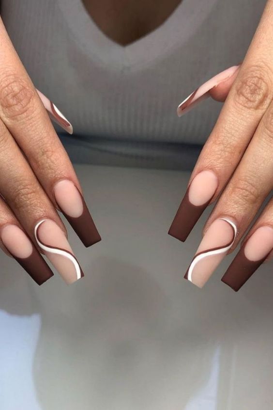 Chocolate French coffin nails with a white swirl, brown tips with one white marble accent