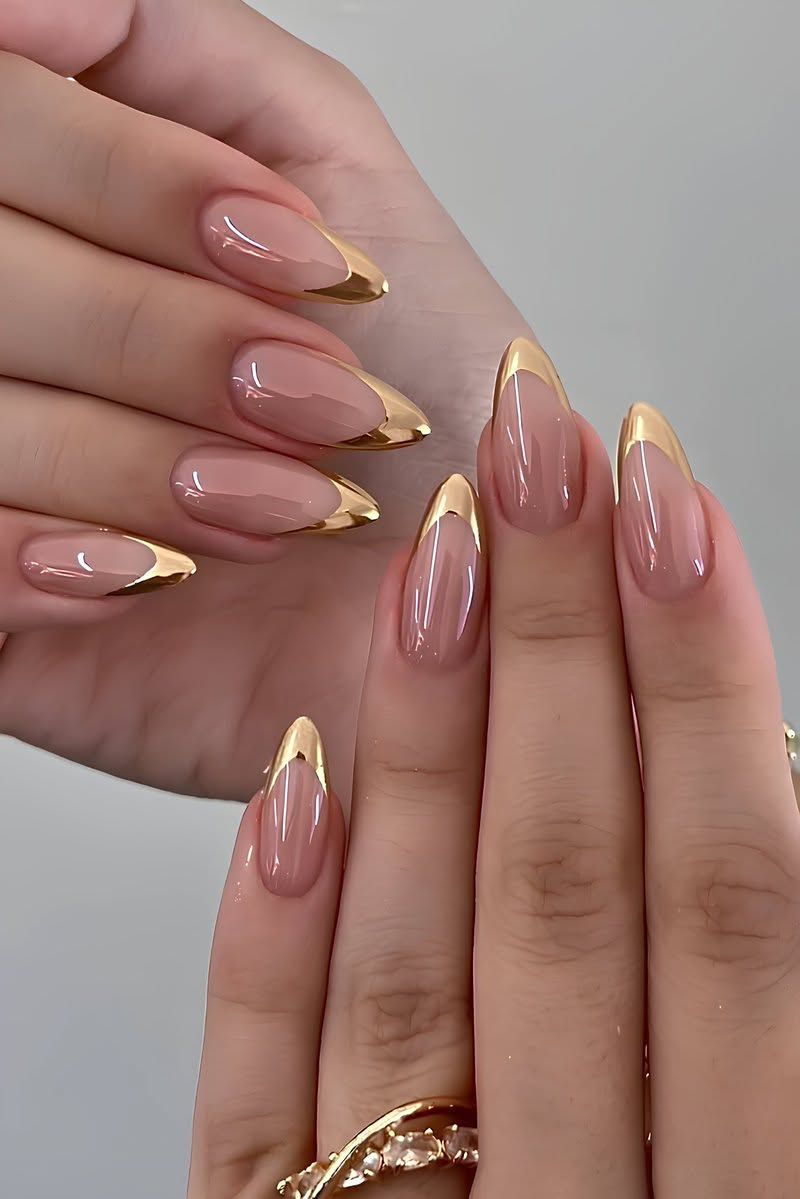 Gold metallic French almond nails, sheer base with mirror gold tips