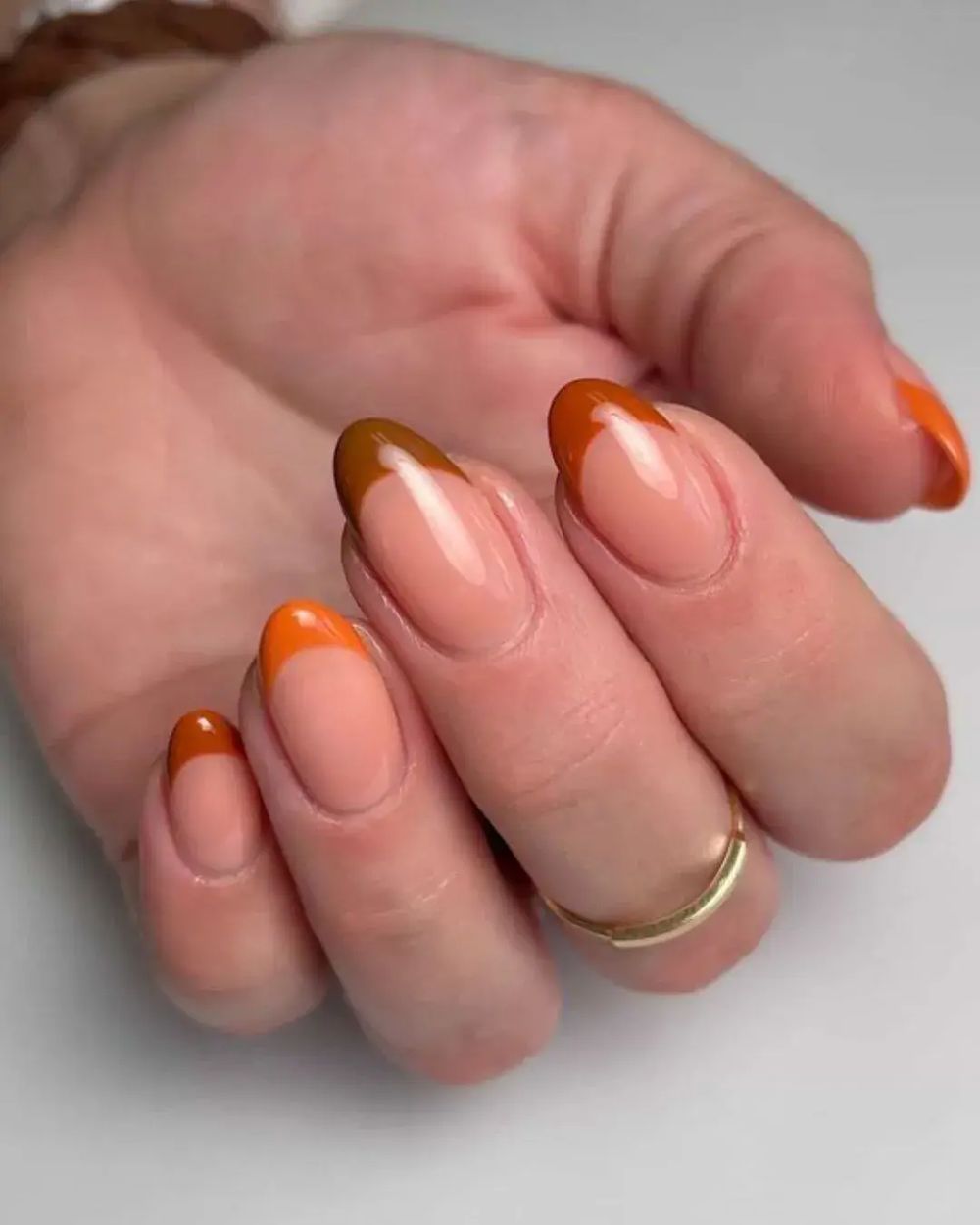 Orange caramel French short oval nails, warm amber tips on short ovals