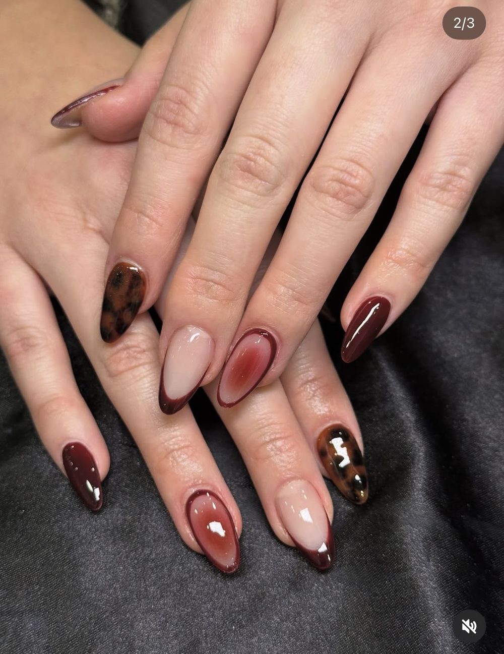Tortoiseshell and burgundy French almond nails, tortoise tips beside wine tips
