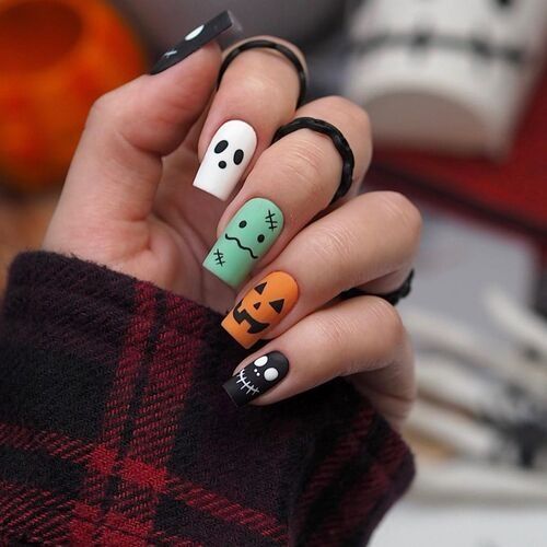 Frankenstein and pumpkin art short nails, green stitched face and orange pumpkin accents