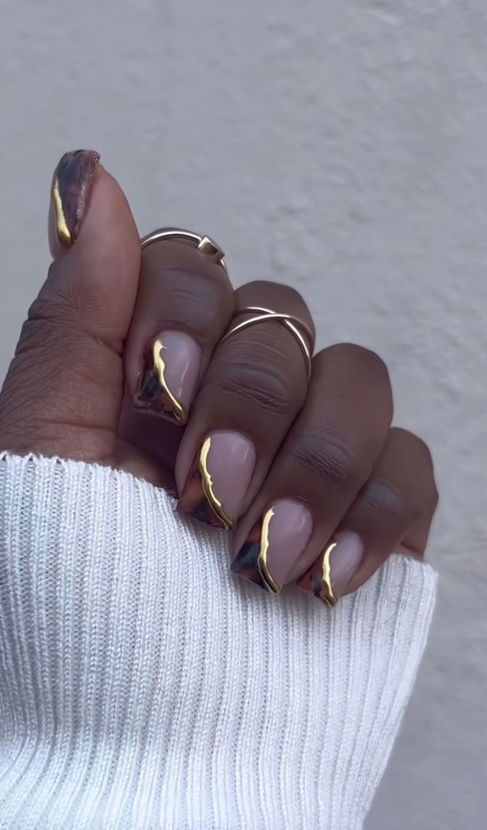 Gold outline French short nails on dark skin, nude base with metallic gold French outlines