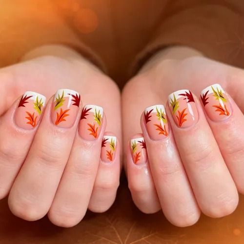 Maple leaf art short nails, clear base with red and orange hand painted maple leaves