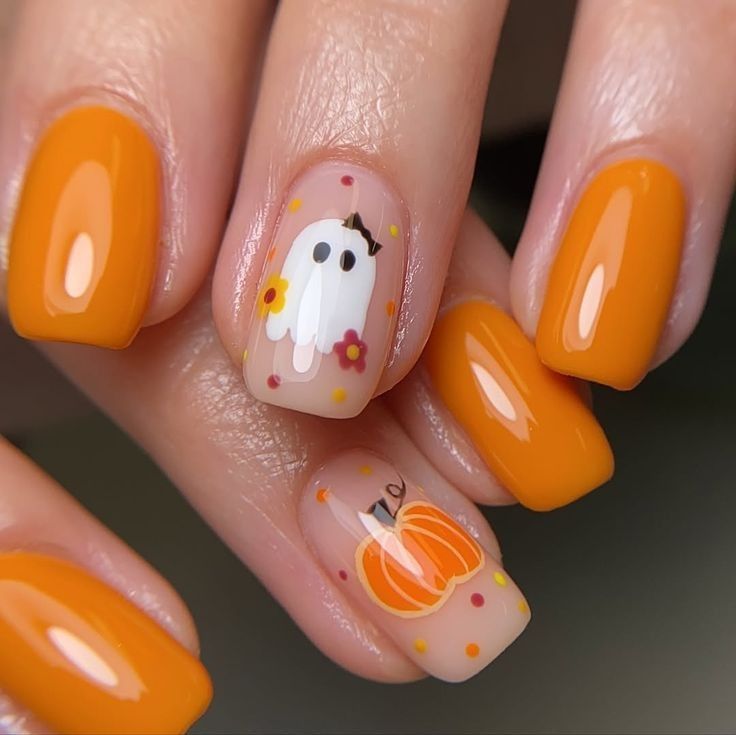 Pumpkin orange short nails with ghost art, orange gel with a white ghost and pumpkin accents