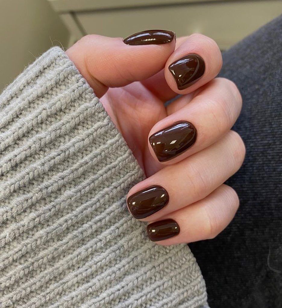 Chocolate short square nails in a grey knit, rich brown short set with a sweater sleeve