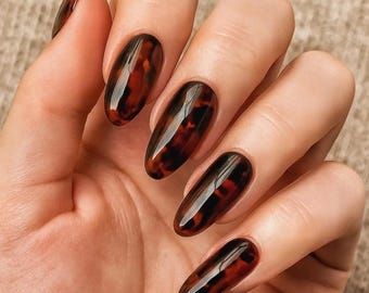 Dark glossy tortoiseshell almond nails, deep smoky amber marble almond set
