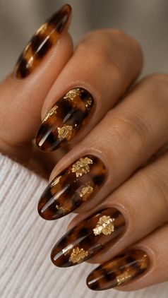 Tortoiseshell almond nails with gold foil, amber marble with gold flakes