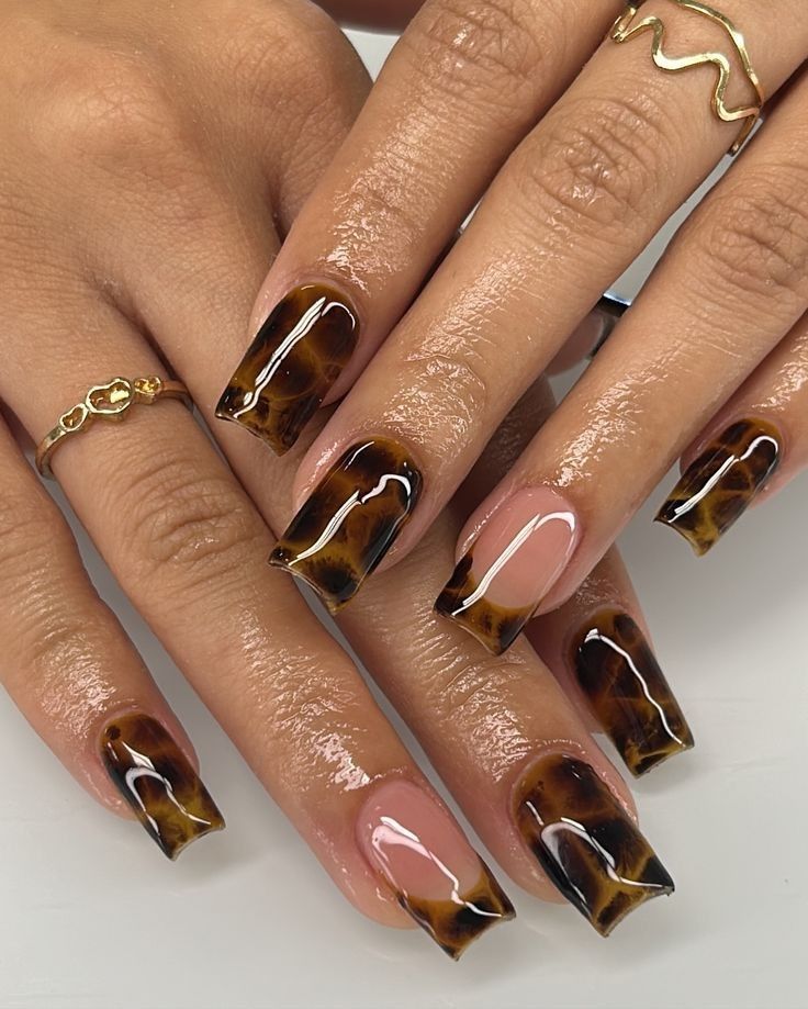 Tortoiseshell coffin nails with a nude accent, amber marble with one bare nail