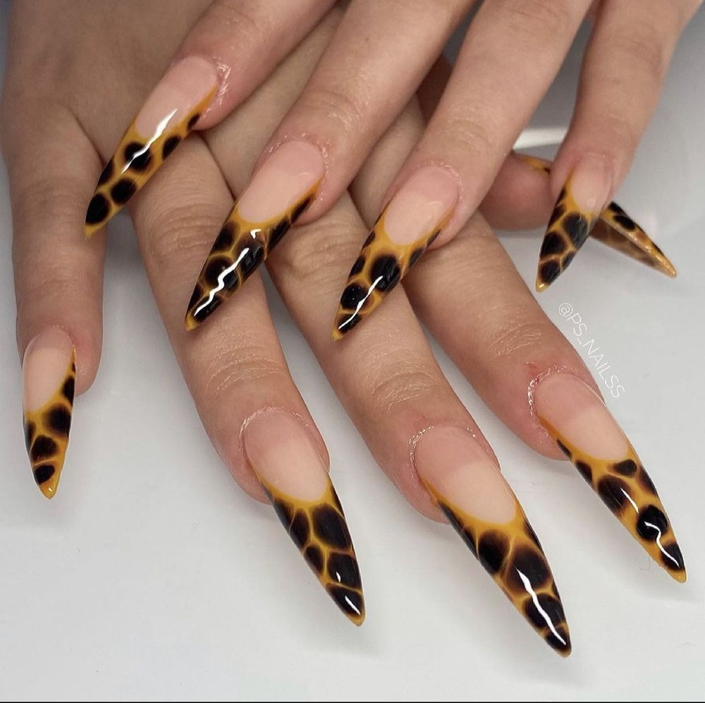 Tortoiseshell French stiletto nails, long nude base with tortoise tips
